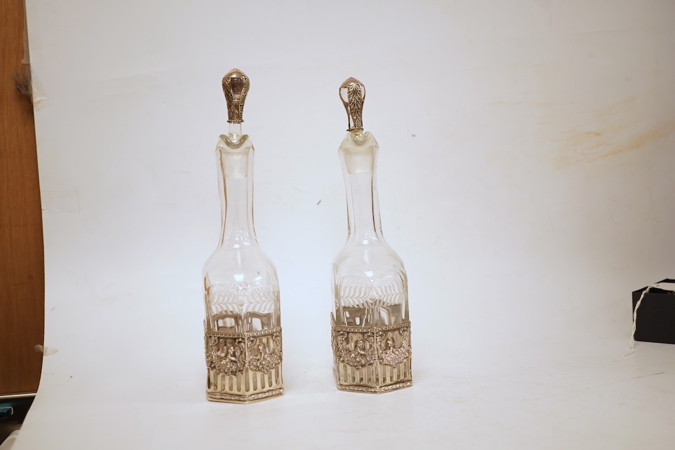 A pair of Hanau silver mounted moulded glass decanters and stoppers, by Berthold Muller, import marks for Glasgow, 1900/1901, 24cm, a.f.